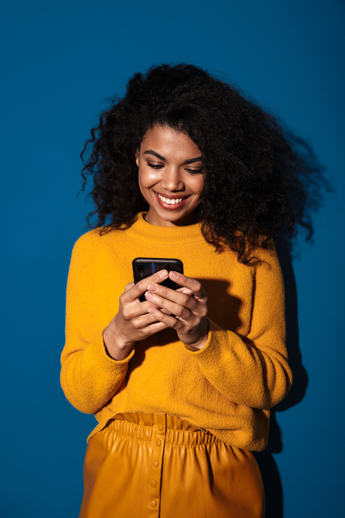 Smiling Happy African Woman Using Mobile Phone.